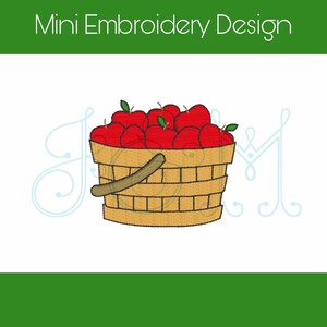 May include: A brown wooden basket filled with red apples. The basket has a brown handle. The apples are arranged in a pile with green leaves on top.