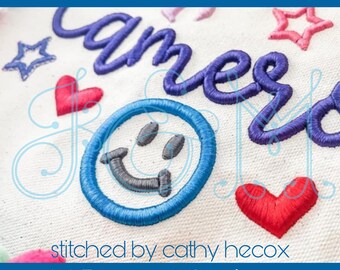 May include: 3D foam embroidery design featuring the word "amer" in purple thread, a smiley face in blue thread, and two red hearts. The design is stitched on a white fabric background. The text "1.5" and "2" sizes" is also included.