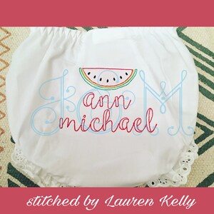 May include: White baby bloomers with a watermelon design and the names "Ann" and "Michael" embroidered in blue and red thread.