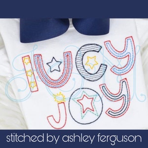 May include: A white onesie with the word "Lucy Joy" embroidered in colorful thread. The letters are outlined in black and decorated with stars and other designs.