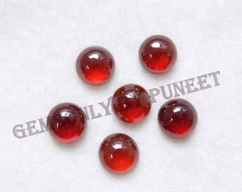 May include: Six round, polished, red gemstones are arranged on a white surface. The gems have a glossy finish and a deep, translucent color. The image includes the text "GEMSONLY PUNEET" and "COPYWRITE BY :-GEMSONLY".