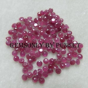 Peut inclure: Une collection d'environ 60 pierres précieuses de rubis roses en vrac. Les pierres précieuses sont facettées et ont une forme ronde. Les pierres précieuses sont dispersées sur une surface blanche. GEMSONLY BY PUNEET est imprimé sur l'image.