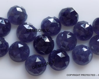 May include: A collection of 14 faceted, round, dark blue gemstones. The gemstones are arranged in a random pattern on a white surface.  The text "GEMSONLY" appears twice in the image.