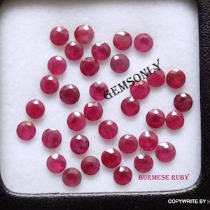 May include: A collection of 25 loose, faceted, red ruby gemstones. The rubies are displayed on a white background with the text "BURMESE RUBY" and "COPYWRITE BY - GEMSONLY".