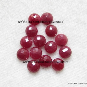 May include: A group of 12 round, faceted ruby gemstones. The gemstones are a deep red color and have a polished finish. www.etsy.com/shop/gemsonly