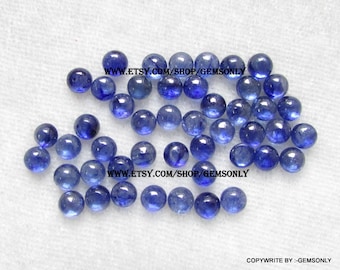 May include: A collection of 30 round, blue sapphire gemstones. The gemstones are approximately 4mm in diameter and have a smooth, polished finish.