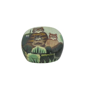 May include: A green, oval-shaped trinket box with a painted design of three cats. The cats are brown, black, and orange with white accents. The box has a lid and is made of wood.