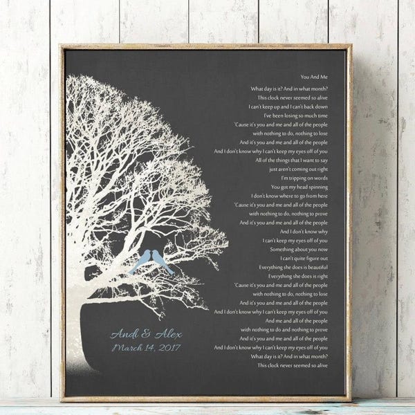 May include: A framed wall art print on a dark gray background featuring a white silhouette of a large tree with two small light blue birds perched on a branch. The text reads You And Me, Andi & Alex, and March 14, 2017, alongside song lyrics.