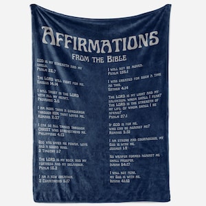 May include: A navy blue throw blanket with white text listing affirmations from the Bible. The text includes various verses and phrases, such as "God is my strength and my shield" and "I will not fear."