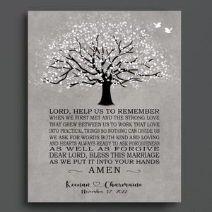 May include: A framed print featuring a stylized black tree with white leaves and two white birds against a gray background. The print includes a prayer and the names "Keenan & Charmaine" with the date "November 17, 2022".