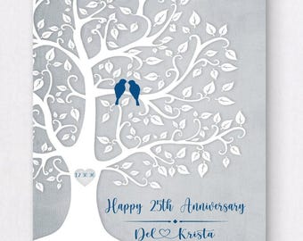 May include: A rectangular wall art print featuring a white tree silhouette on a light gray background. Two dark blue birds sit on a branch. A heart on the trunk displays 12.30.90. Text reads Happy 25th Anniversary and Del and Krista.