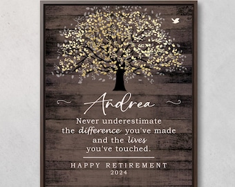 May include: A framed wooden sign with a tree design and the name "Andrea" in cursive. The text reads "Never underestimate the difference you've made and the lives you've touched. HAPPY RETIREMENT 2024."