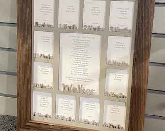 May include: A rectangular wooden frame containing twelve white cards labeled from Newborn to 12 Months, each featuring a quote. A central card displays the poem Children Learn What They Live, with the name Walker positioned below the text.