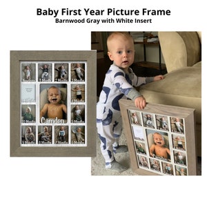 May include: A gray wooden picture frame with a white insert. The frame has 12 openings for photos, each with a white mat. The frame is designed to hold photos of a baby's first year, with labels for each month. The name "Camden" is written on the frame.