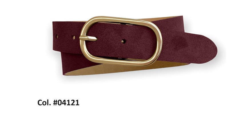 May include: A burgundy belt with a matte texture and a smooth, oval-shaped gold-tone metal buckle. The belt features a series of adjustment holes and is labeled with the text Col. #04121. The strap has a light-colored interior lining.