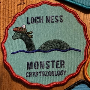 Loch Ness Monster Cryptozoology embroidered cryptid patch mysterious supernatural lizard.