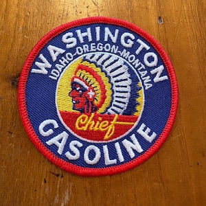 May include: Round patch with a red border, featuring the text "WASHINGTON, IDAHO, OREGON, MONTANA" in white. The center has a Native American chief graphic and the words "Chief Gasoline".