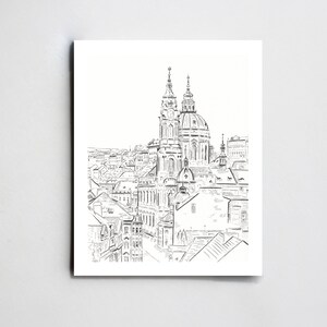 May include: A black and white line drawing of a cityscape with a prominent church in the center. The church has two towers and a dome. The drawing is done in a simple style, with a focus on the architecture of the buildings.