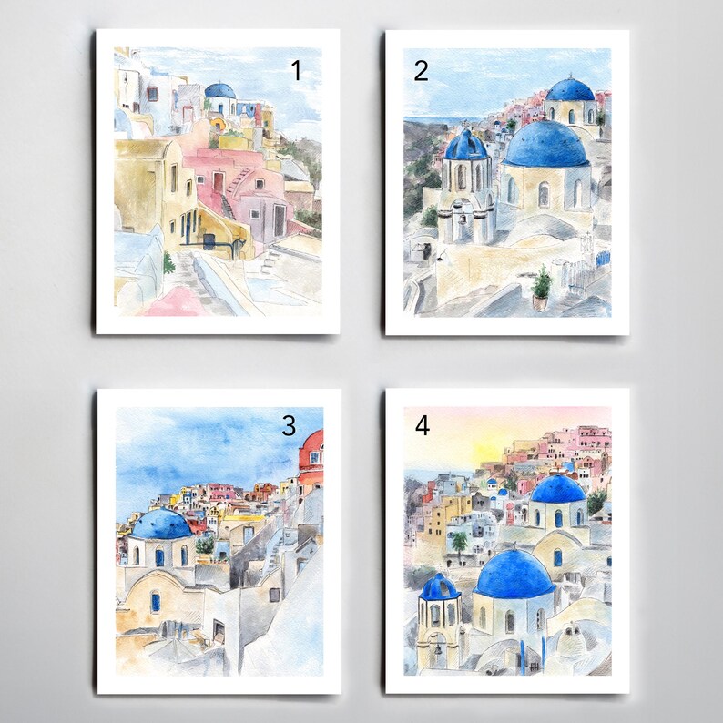 May include: Four watercolor paintings of a Greek island village with white buildings and blue domed churches. The paintings are numbered 1 through 4.