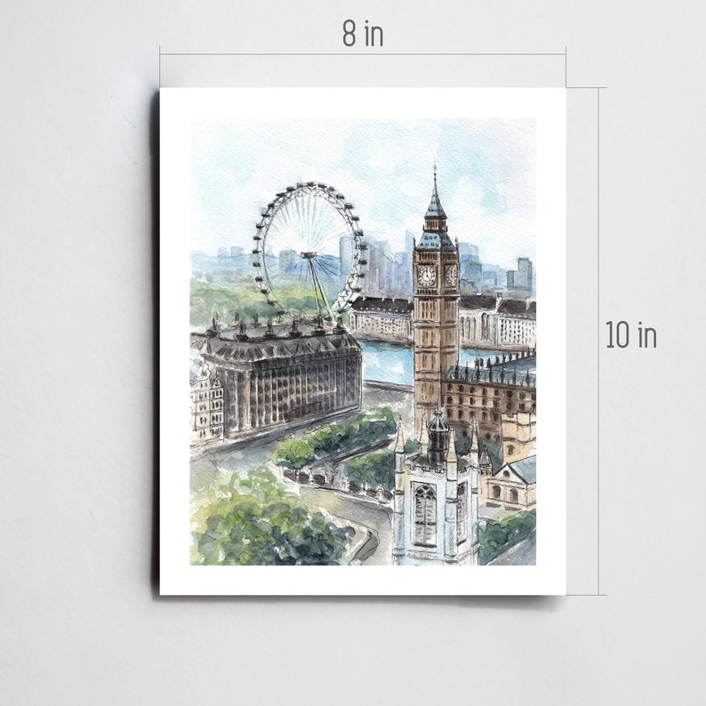 May include: Watercolor print of London landmarks, including the London Eye and Big Ben. The artwork is 8 inches wide and 10 inches tall. The print features a soft color palette of blues, greens, and browns, capturing a scenic cityscape.