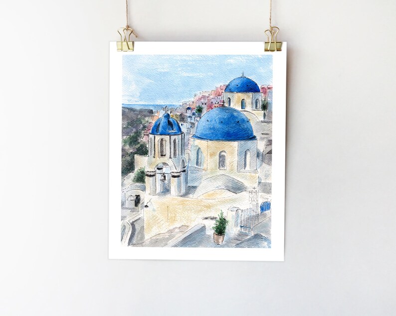 May include: Watercolor painting of a white building with blue domed roofs in a village setting. The building has a bell tower and is surrounded by other buildings.