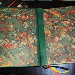 May include: A green, red, and yellow marbled book cover with a green leather spine.
