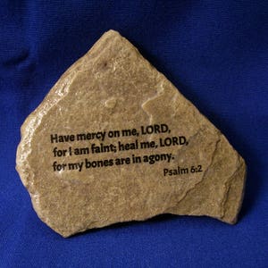 May include: A brown stone with the text "Have mercy on me, LORD, for I am faint; heal me, LORD, for my bones are in agony. Psalm 6:2" engraved on it.