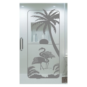 May include: A glass shower door featuring a gray flamingo and palm tree design. The design includes a large palm tree, two flamingos, and smaller palm trees at the bottom. The door has a silver handle.