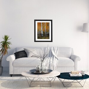May include: A framed print of a painting depicting a group of birch trees with yellow leaves in an autumnal forest setting.