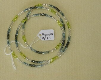 May include: A multi-strand beaded necklace with green, blue, and silver beads. The necklace has a tag attached that reads "Agender Pride".