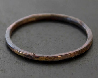 Skinny burnt 10k gold band ring with a wabi sabi organic silhouette. Hammered + oxidized gold ring. Hand crafted.