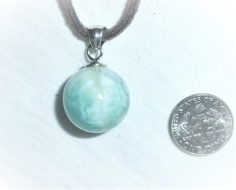 May include: A silver pendant necklace with a light blue and white round gemstone. The gemstone has a swirling pattern.