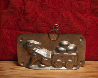 Antique Easter two part chocolate mold of a bunny pulling egg cart