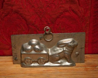 Antique Easter two part chocolate mold of a bunny pulling egg cart