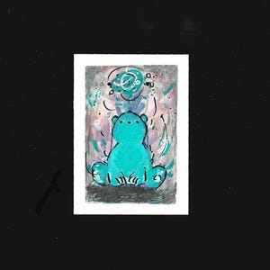 May include: A whimsical illustration of a teal bear with a halo-like design above its head. The bear is seated, with a light background of pink, gray, and teal brushstrokes. The artwork is on a white rectangular card.