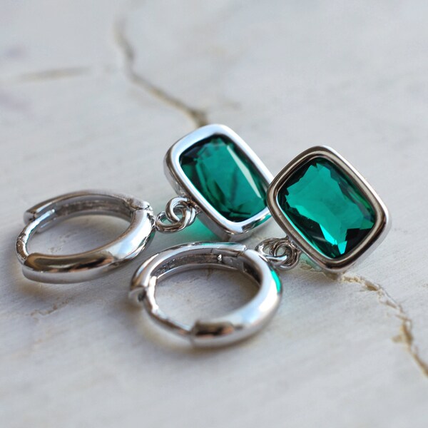 Rhodium plated hoop earrings with framed faceted emerald glass charms . gifts for her