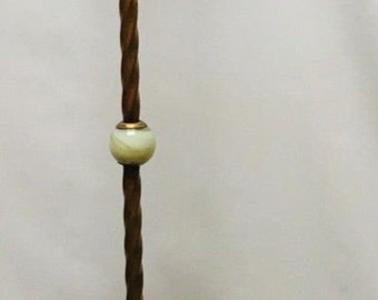 May include: A gold floor lamp with a twisted stem and a decorative base. The lamp has a white glass shade and a pull chain.