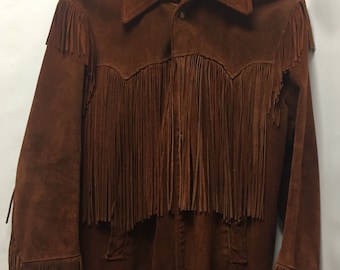 May include: A brown suede jacket with fringe detailing. The jacket has a button-up front and long sleeves.