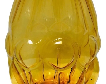 May include: A amber glass vase with a unique, textured, bulbous shape. The vase has a rounded bottom and a wide opening.