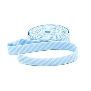 May include: A roll of light blue and white striped bias tape, unrolled on a white background. The fabric is a light blue with thin white stripes running diagonally across the tape. The tape is rolled into a spiral.