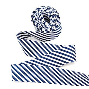 May include: A roll of navy blue and white striped ribbon, unraveled to show the pattern. The ribbon is made of a flexible material and is suitable for various crafting and decorative purposes. The stripes are evenly spaced and create a classic nautical look.