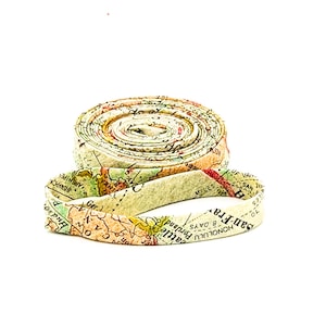 May include: A rolled up fabric ribbon with a vintage map print featuring city names like "Honolulu", "San F.R.", "Seattle", and "Portland".
