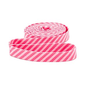 May include: A roll of pink and white striped bias tape, with a length of the tape unrolled in the foreground. The tape is made of fabric and is suitable for sewing and crafting projects. The diagonal stripes create a visually appealing pattern.