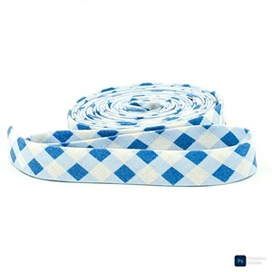May include: A roll of blue and white gingham bias tape. The fabric is a light blue and white checkered pattern. The tape is rolled up in a spiral, with a length of the tape unrolled in the foreground.
