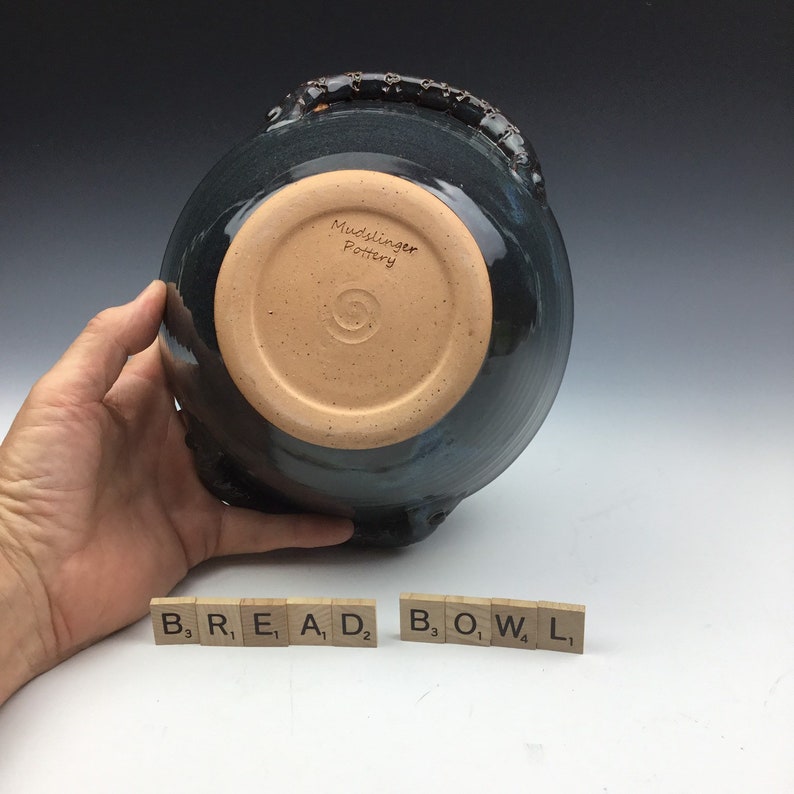 Handmade ceramic serving bread bowl with handles in blue.