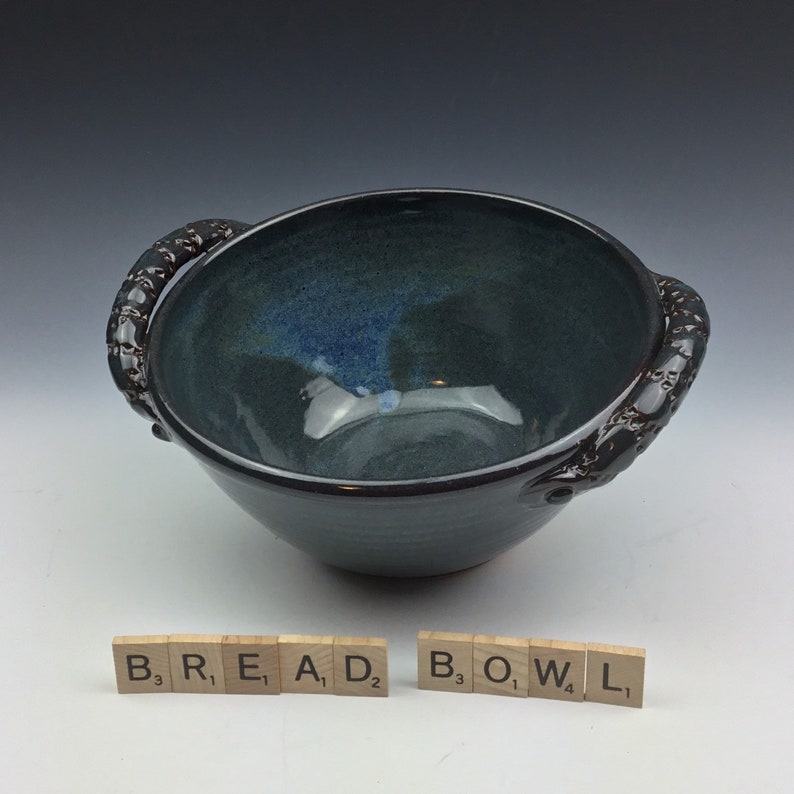 Handmade ceramic serving bread bowl with handles in blue.