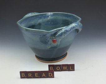Handmade ceramic serving bread bowl with handles in blue.