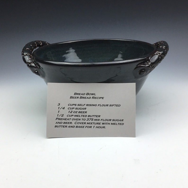 Handmade ceramic serving bread bowl with handles in blue.