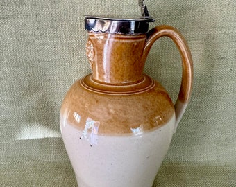 Antique English Stoneware Bacchus Wine Jug with Faces and Sterling Cap