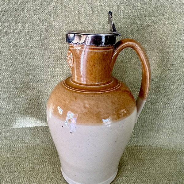 Antique English Stoneware Bacchus Wine Jug with Faces and Sterling Cap